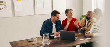 four people having a meeting