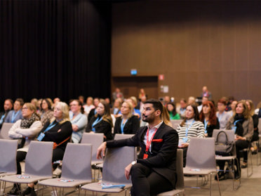 man listening at a conference