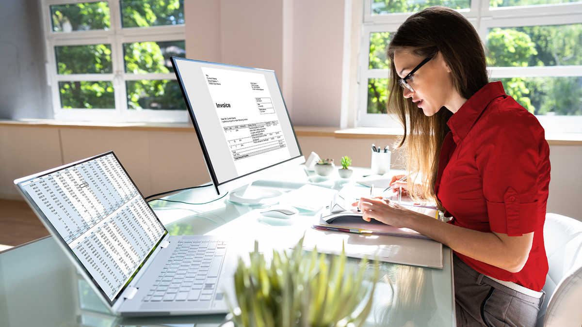 woman working at desk with invoices