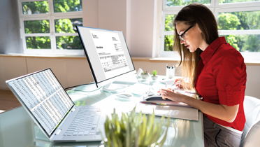 woman working at desk with invoices