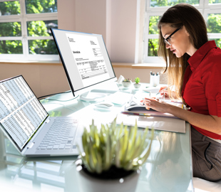 woman working at desk with invoices
