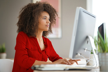 focused business woman looking at computer