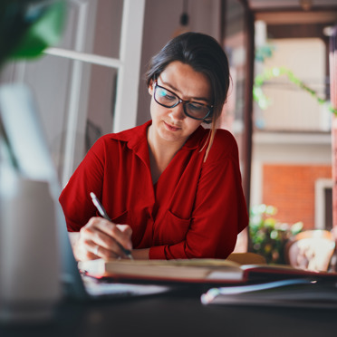 woman writing at her desk