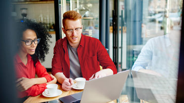 man and woman looking at laptop screen