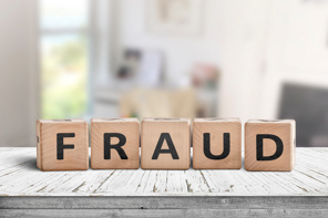 Fraud spelled out in wooden blocks