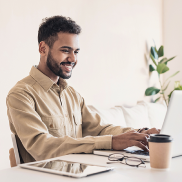 man smiling at computer