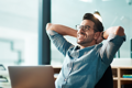 man leaning back on chair