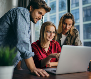 Young professionals looking at screen 