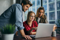 Young professionals looking at screen