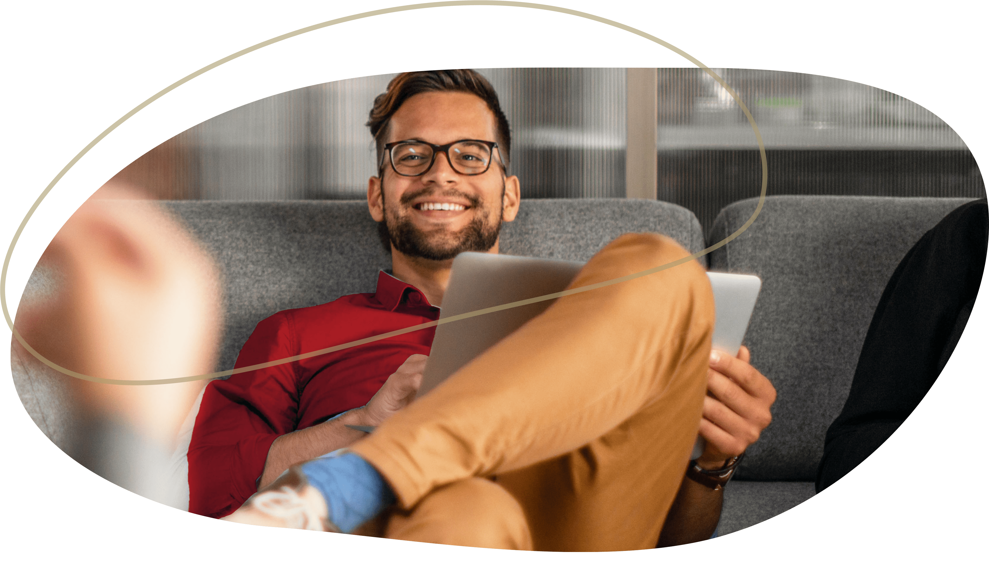 man smiling and working on a laptop