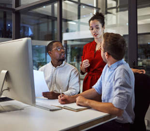 three people talking in office at evening