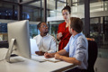 three people talking in office at evening