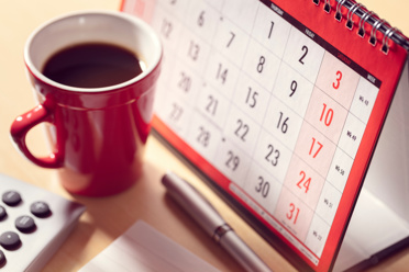 coffee and calendar sitting on desk