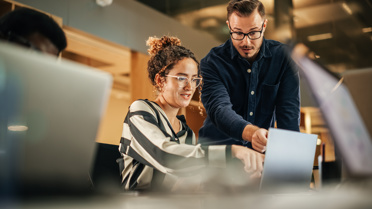 Coworkers Working Together by  laptop