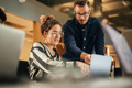 Coworkers Working Together by  laptop